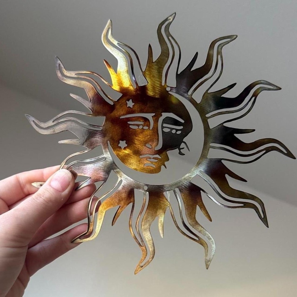 Celestial metal sun and moon wall art with face design